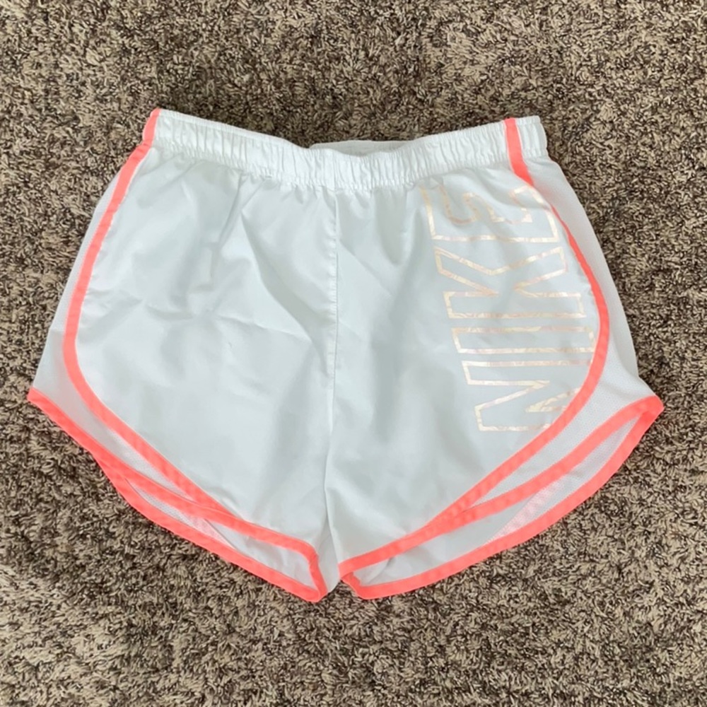 White and pink Nike running shorts
